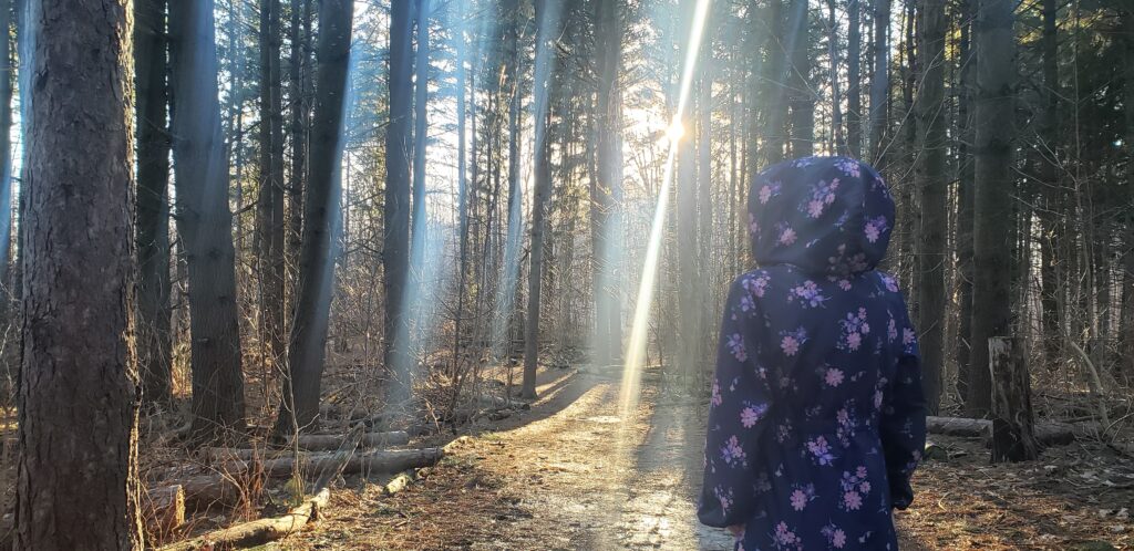 daughter in sunlight ray forest